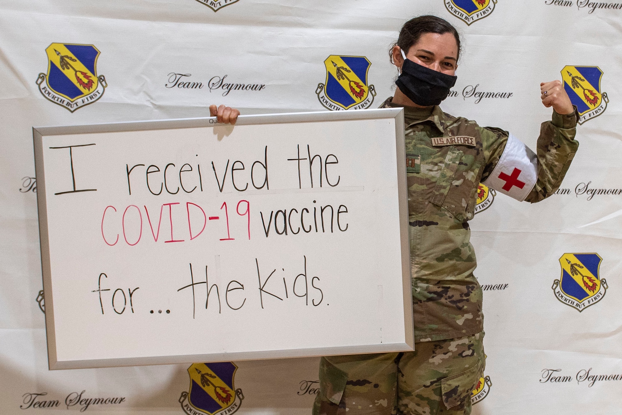 Captain Peri Fouss, 4th Healthcare Operation Squadron medical director of pediatrics and immunizations, holds up a sign after receiving the COVID-19 vaccine at Seymour Johnson Air Force Base, North Carolina, Jan. 15, 2021.