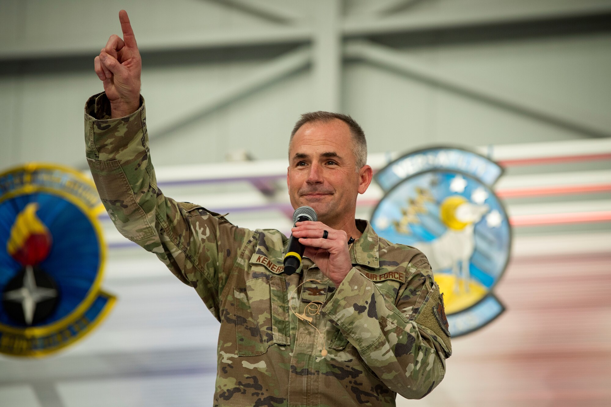 Col. Kenerson holds up the number one.