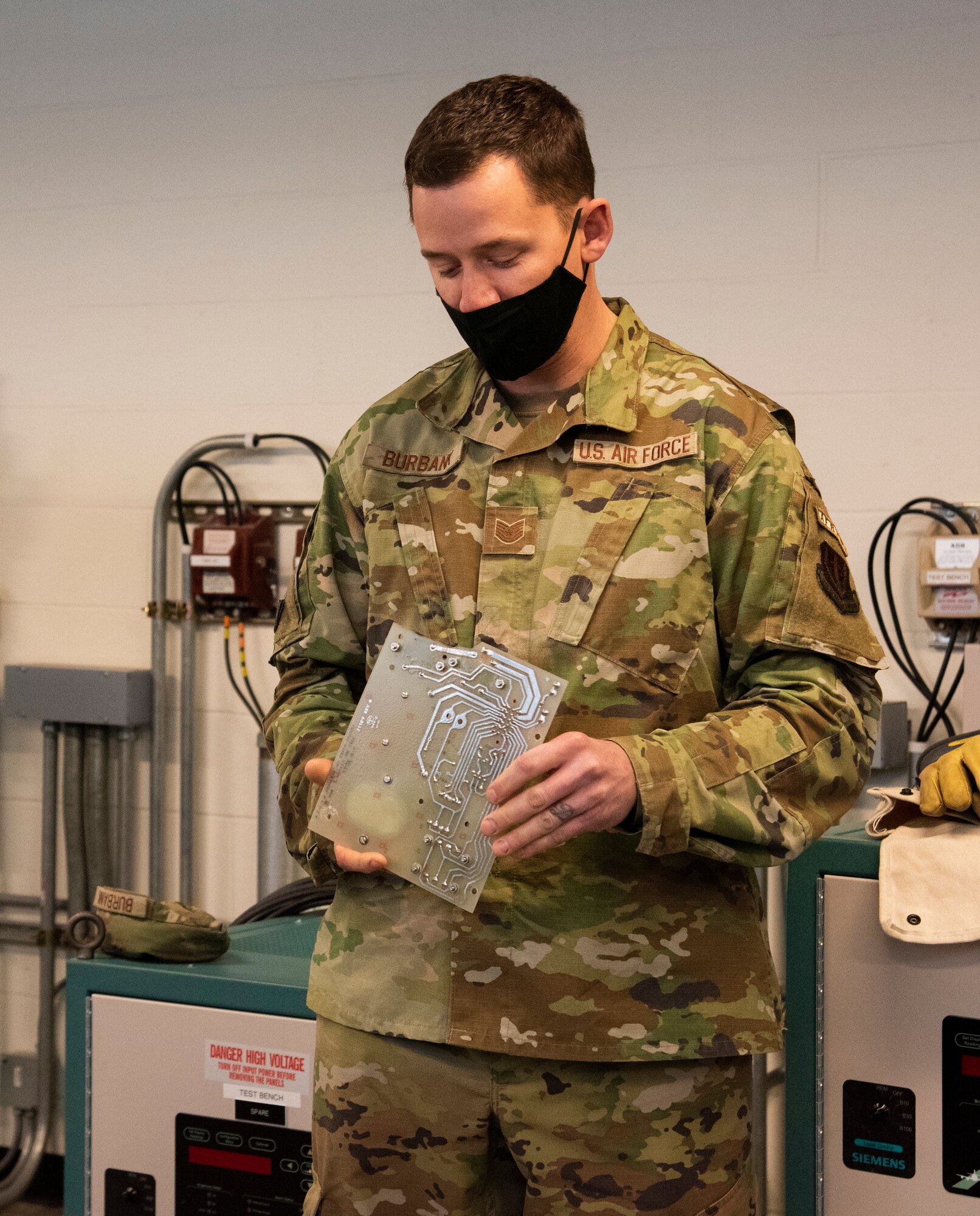 Tech. Sgt. Brian Burbank, AFREP NCOIC, talks about a circuit board for a Constant Current Regulator at Mountain Home Air Force Base, Idaho, Jan. 8, 2021. Burbank rebuilt this circuit board for the regulator to maintain mission readiness on the base.
