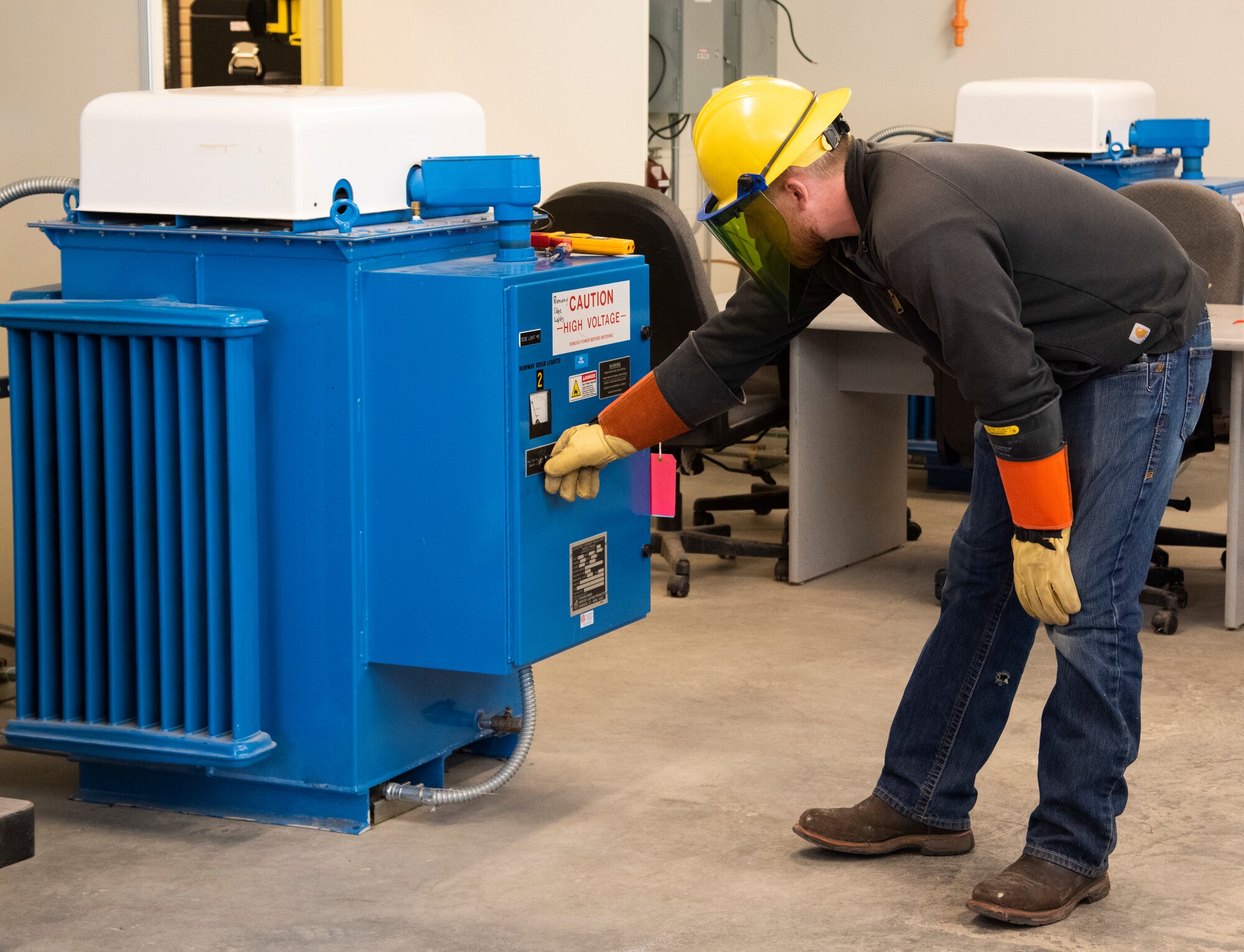 Ryan Prussner, high voltage foreman, turns on a Constant Current Regulator at Mountain Home Air Force Base, Idaho, Jan. 8, 2021. Prussner was starting the machine to test a new circuit board created for the regulator.