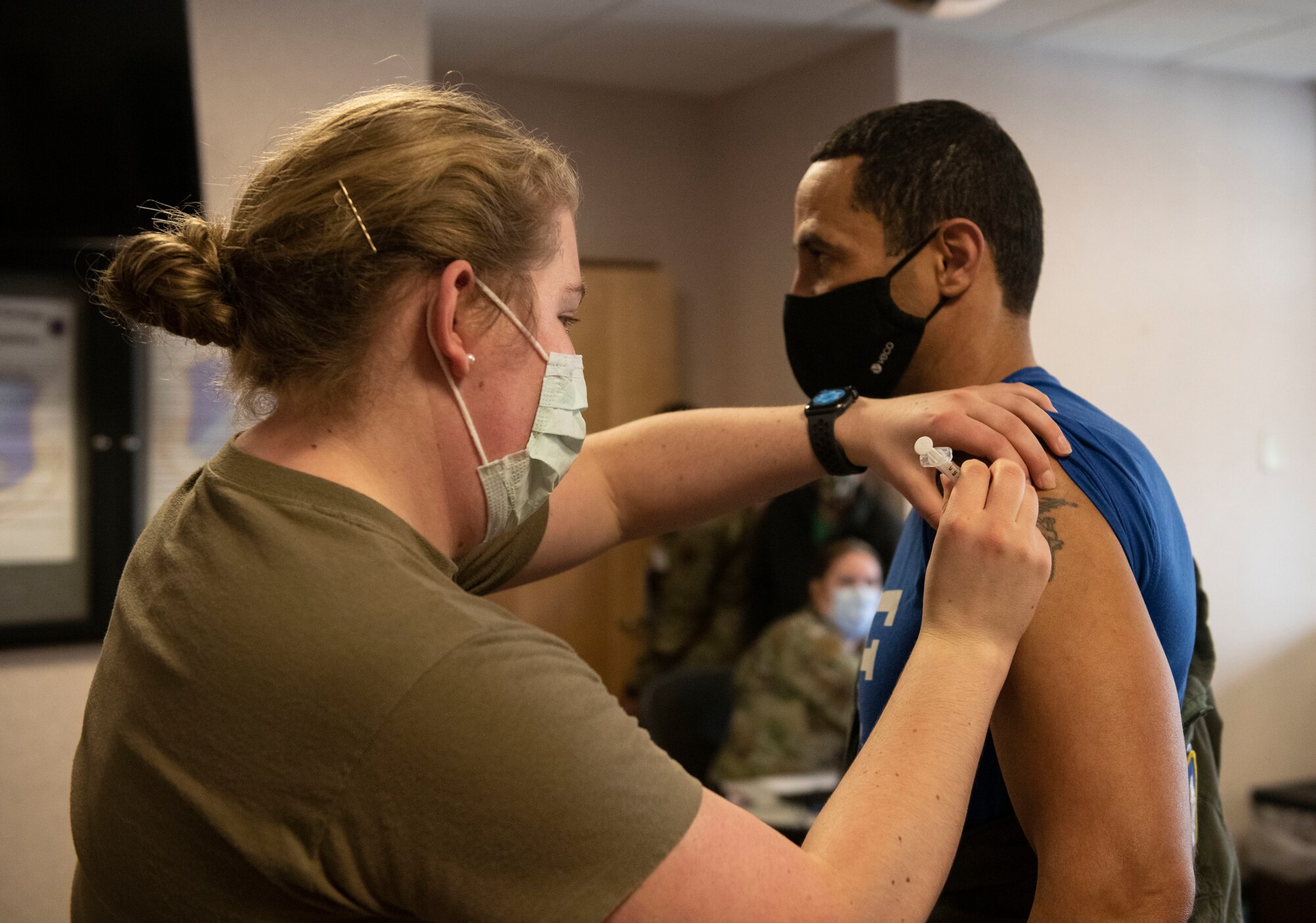 Staff Sgt. Alexandria Lovell, 319th Health Care Operations Squadron family medicine noncommissioned officer in charge, administers a COVID-19 vaccine to Col. Timothy Curry, 319th Reconnaissance Wing vice commander, at Grand Forks Air Force Base, N.D., Jan. 22, 2021. The vaccine was authorized for emergency use by the U.S. Food and Drug Administration after undergoing careful and rigorous testing and trials.