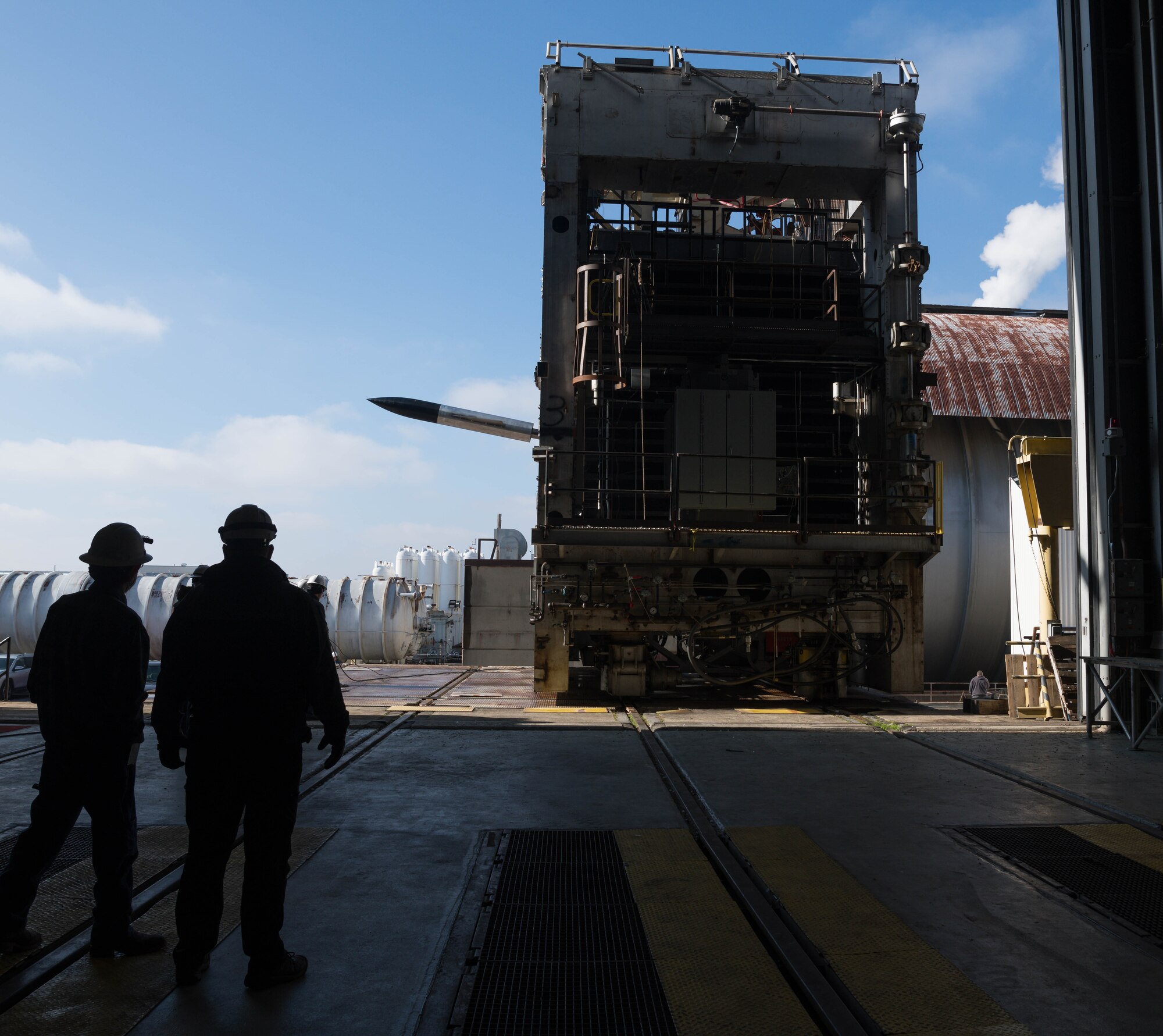 Arnold Engineering Development Complex team members watch as a test cart is moved off a transfer cart and into the high bay of the 16-foot supersonic wind tunnel, Jan. 12, 2021, at Arnold Air Force Base, Tenn. (U.S. Air Force photo by Jill Pickett)