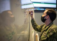 JOINT BASE LANGLEY-EUSTIS, Va. (Jan. 26, 2021) Navy Operations Specialist 2nd Class Dillon Devillier, assigned to Joint Task Force Civil Support (JTF-CS), updates a significant actions matrix on a whiteboard as part of his watch-standing duties in the Joint Operations Center at JTF-CS headquarters during Exercise Sudden Response 21.