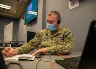 JOINT BASE LANGLEY-EUSTIS, Va. (Jan. 26, 2021) Navy Chief Damage Controlman Kevin Fischbach, the Joint Task Force Civil Support J34 protection cell non-commissioned officer in charge, takes notes during a training brief hosted on a virtual collaboration tool during Exercise Sudden Response 21.