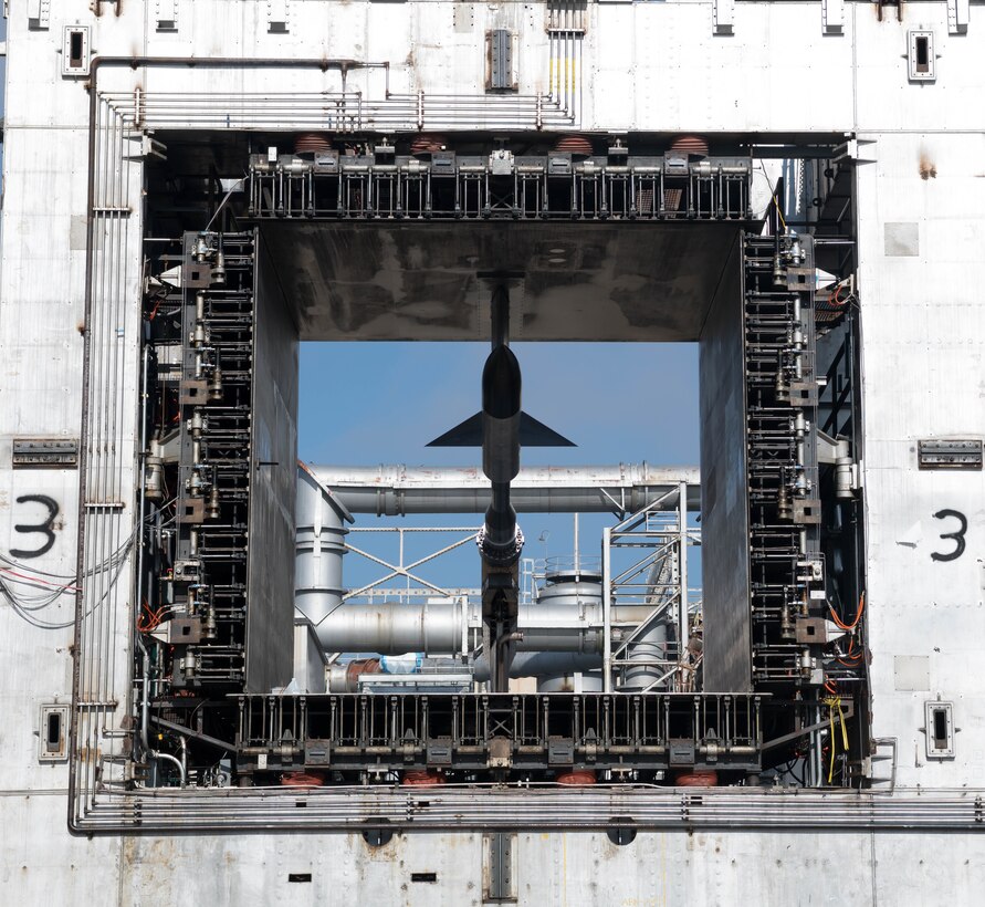 Ductwork of the Propulsion Wind Tunnel Facility is seen in the background as a test cart with an AGARD-B model installed moves from the Model Installation Building to the 16-foot supersonic wind tunnel, Jan. 12, 2021, at Arnold Air Force Base, Tenn. (U.S. Air Force photo by Jill Pickett)