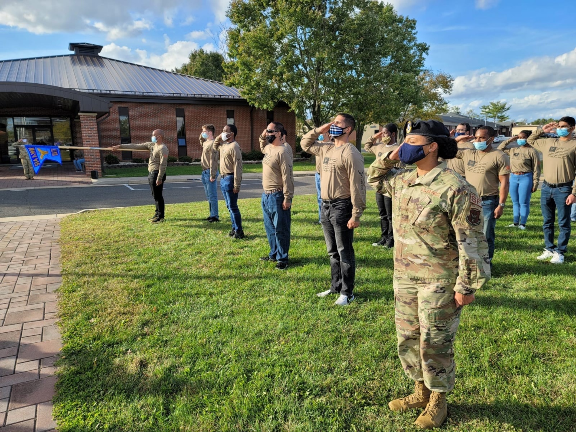 Tech. Sgt. Kristine Glenn, Developmental and Training Flight noncommissioned officer in charge, salutes during final retreat at the 514th Air Mobility Wing, Joint Base McGuire-Dix-Lakehurst, N.J. on November, 14, 2020 .  Photo by Air Force Tech. Sgt. Michael K. Hong