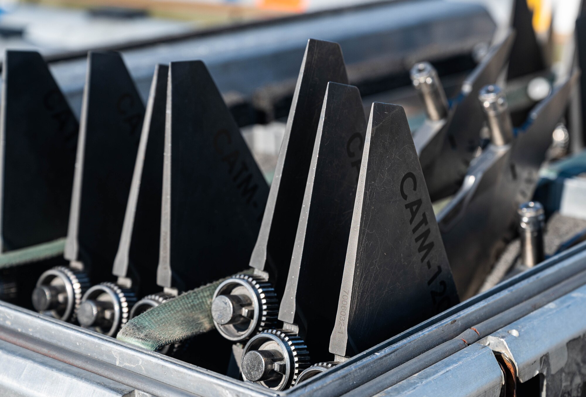 Fins for a missile sit in a crate.