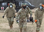 Reserve Citizen Airmen from the 433rd Aeromedical Staging Squadron transport a simulated injured patient from a UH-60 Black Hawk to a Humvee for training Jan 9, 2021 at Joint Base San Antonio-Chapman Training Annex. The training helped provide experience to medics in receiving and transporting combat injured individuals. (U.S. Air Force photo by Tech. Sgt. Mike Lahrman)