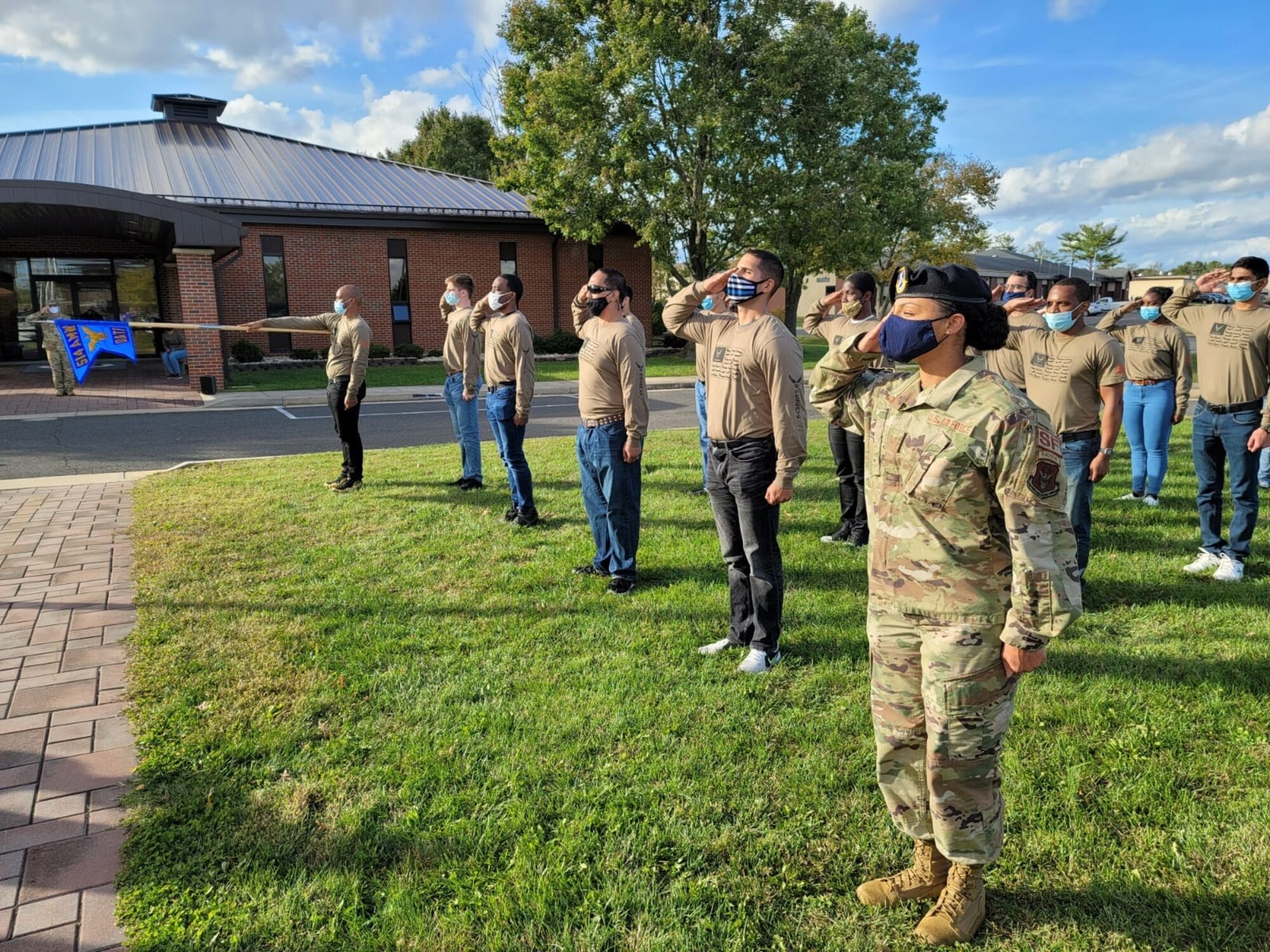 Tech. Sgt. Kristine Glenn, Developmental and Training Flight noncommissioned officer in charge, salutes during final retreat at the 514th Air Mobility Wing, Joint Base McGuire-Dix-Lakehurst, N.J. on November, 14, 2020 .  Photo by Air Force Tech. Sgt. Michael K. Hong