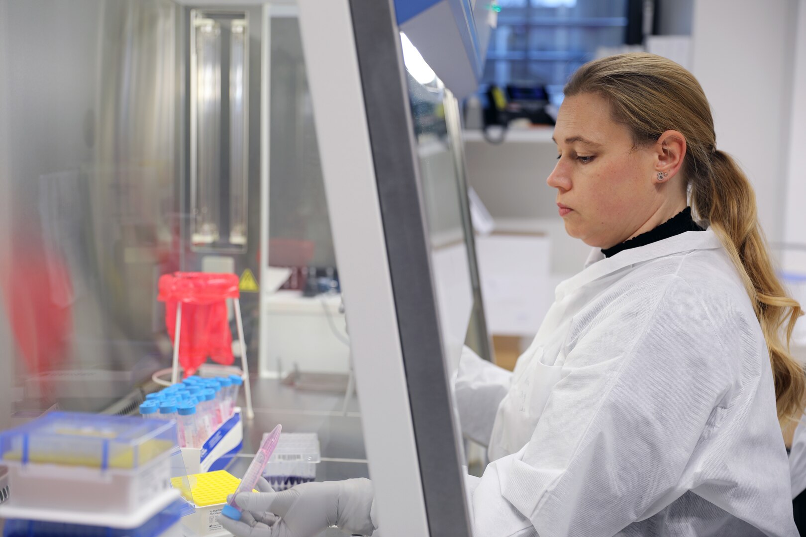 Nina Gruhn, a senior microbiologist in the Biological Analysis Division at Public Health Command Europe, demonstrates the COVID-19 surveillance testing process.