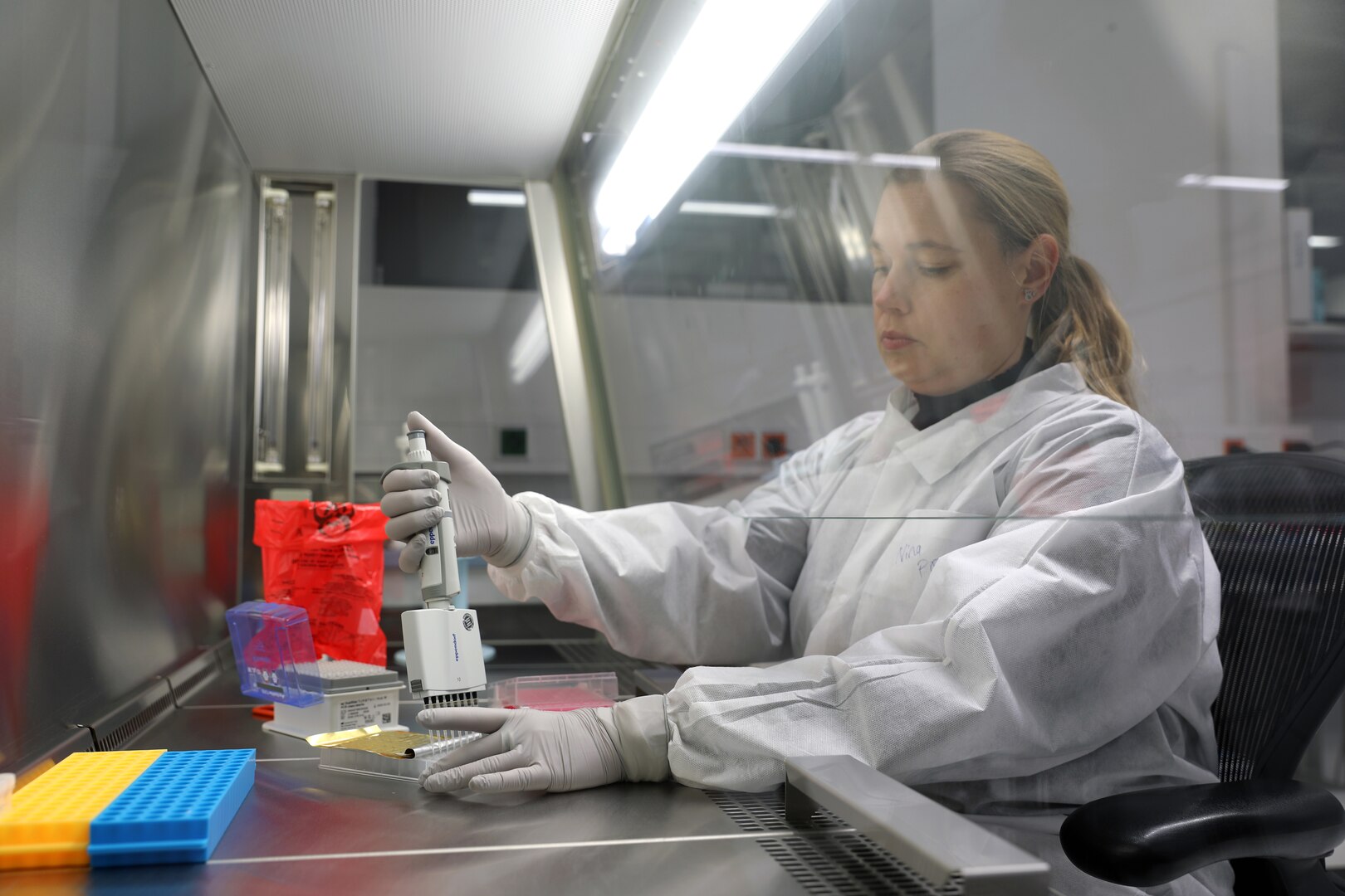 Nina Gruhn, a senior microbiologist in the Biological Analysis Division at Public Health Command Europe, demonstrates the COVID-19 surveillance testing process.