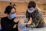 Army Spc. Hana Lee, a dental specialist assigned to the Baumholder Army Dental Clinic, receives her first dose of the COVID vaccine. Dental care providers and staff were included as part of the initial distribution since performing dental procedures puts them at high risk for exposure to COVID-19
