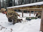 Sgt. Michael Metcalf and Spc. Walter Galdamez train for the 2021 Command Sgt. Maj. Jack L. Clark Jr. U.S. Army Best Medic Competition by evacuating a simulated injured Soldier.