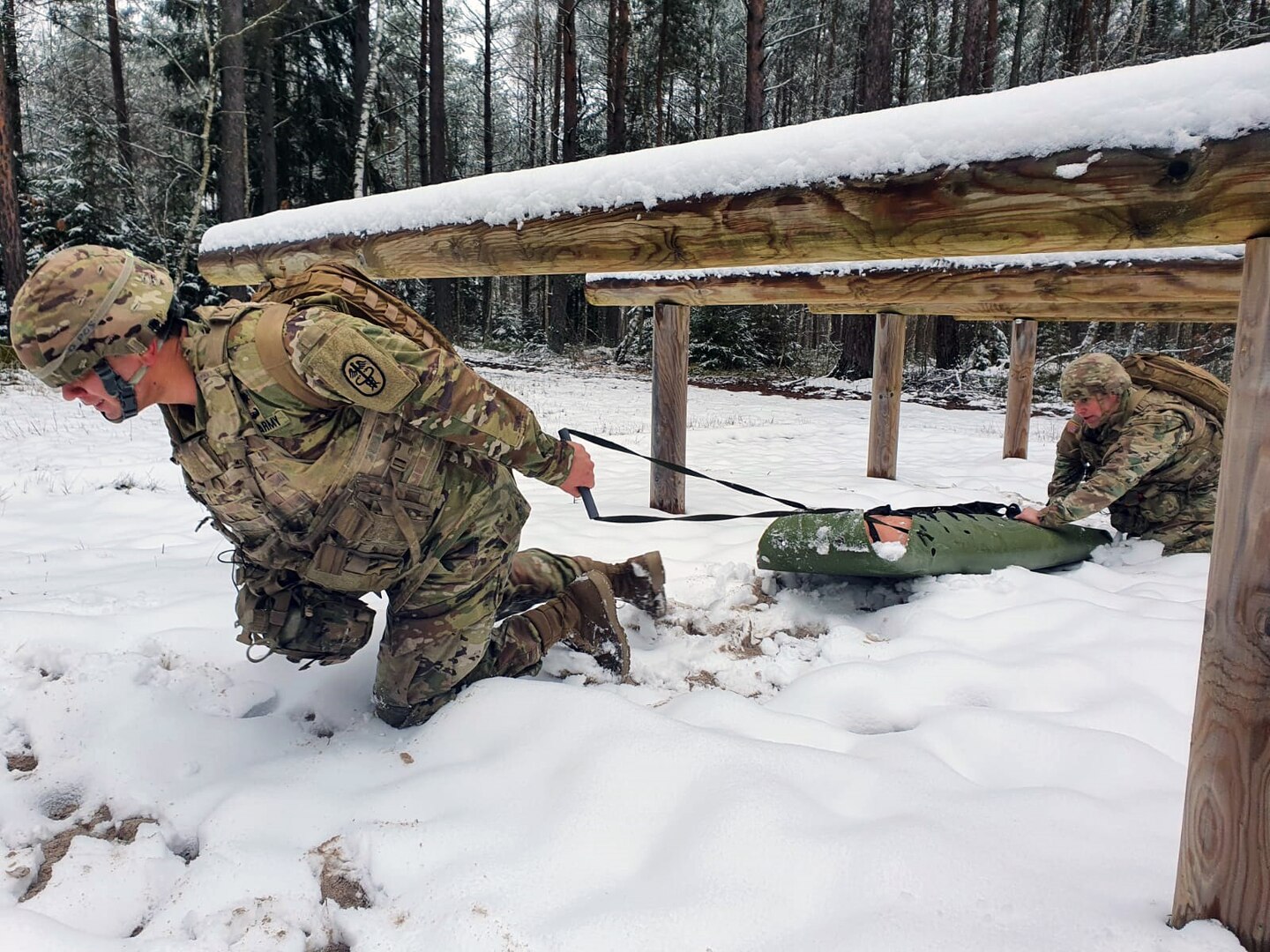 Sgt. Michael Metcalf and Spc. Walter Galdamez train for the 2021 Command Sgt. Maj. Jack L. Clark Jr. U.S. Army Best Medic Competition by evacuating a simulated injured Soldier.