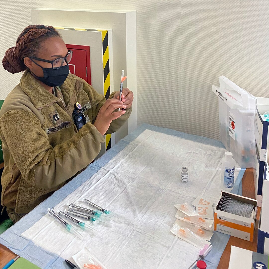 Capt. Ashley Jefferson-Watts, a clinical nurse and officer in charge of the primary care clinic at U.S. Army Health Clinic Grafenwoehr, prepares a Moderna COVID-19 vaccine.