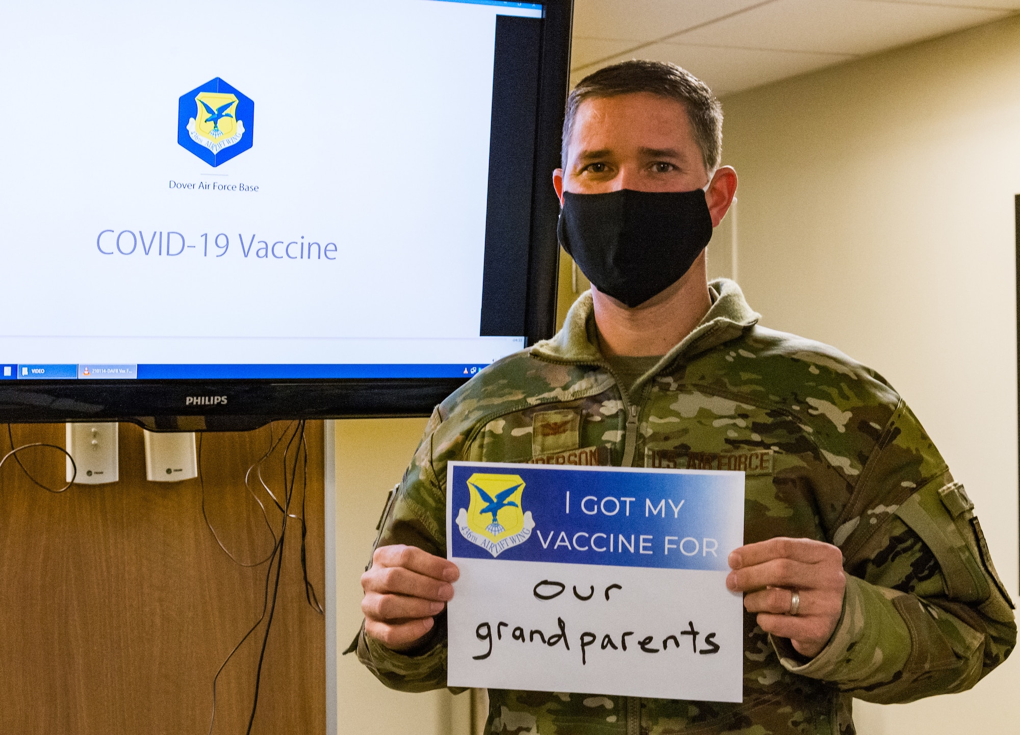 Col. Shanon Anderson, 436th Airlift Wing vice commander, displays a sign stating why he volunteered for the COVID-19 vaccination Jan. 20, 2021, at Dover Air Force Base, Delaware. Anderson was among the first Team Dover senior leaders who voluntarily received the vaccine in accordance with Department of Defense guidance. The vaccine was granted emergency use authorization by the U.S. Food and Drug Administration for use in prevention of COVID-19. (U.S. Air Force photo by Roland Balik)