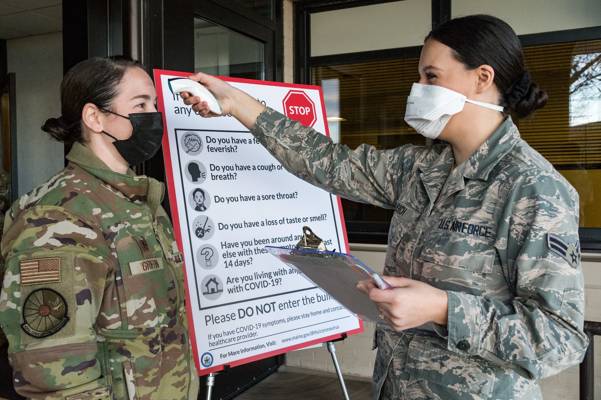 Maj. Kady Griffin, 436th Force Support Squadron commander, has her temperature taken by Airman 1st Class Hope Vusich, 436th Operational Medical Readiness Squadron mental health technician, prior to entering the 436th Medical Group Clinic Jan. 22, 2021, at Dover Air Force Base, Delaware. Griffin was among the first Team Dover senior leaders who voluntarily received the vaccine in accordance with Department of Defense guidance. The vaccine was granted emergency use authorization by the U.S. Food and Drug Administration for use in prevention of COVID-19. (U.S. Air Force photo by Roland Balik)