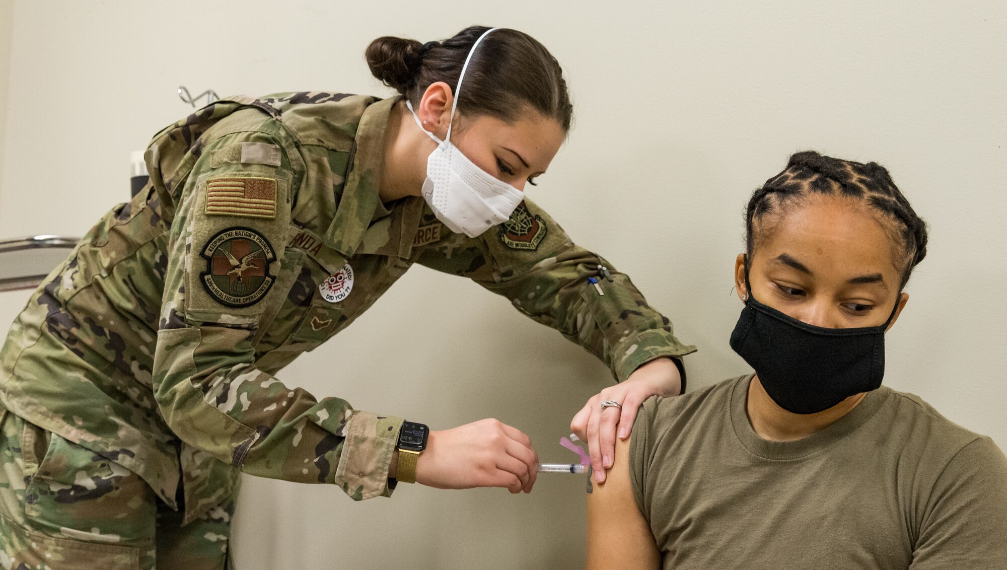 Tech. Sgt. Tiana White, 436th Airlift Wing Tactics and Leadership Nexus cadre, receives the COVID-19 vaccine administered by Airman 1st Class Madelyn Renda, 436th Healthcare Operations Squadron medical technician, Jan. 22, 2021, at Dover Air Force Base, Delaware. White was among the first Team Dover members who voluntarily received the vaccine in accordance with Department of Defense guidance. The vaccine was granted emergency use authorization by the U.S. Food and Drug Administration for use in prevention of COVID-19. (U.S. Air Force photo by Roland Balik)