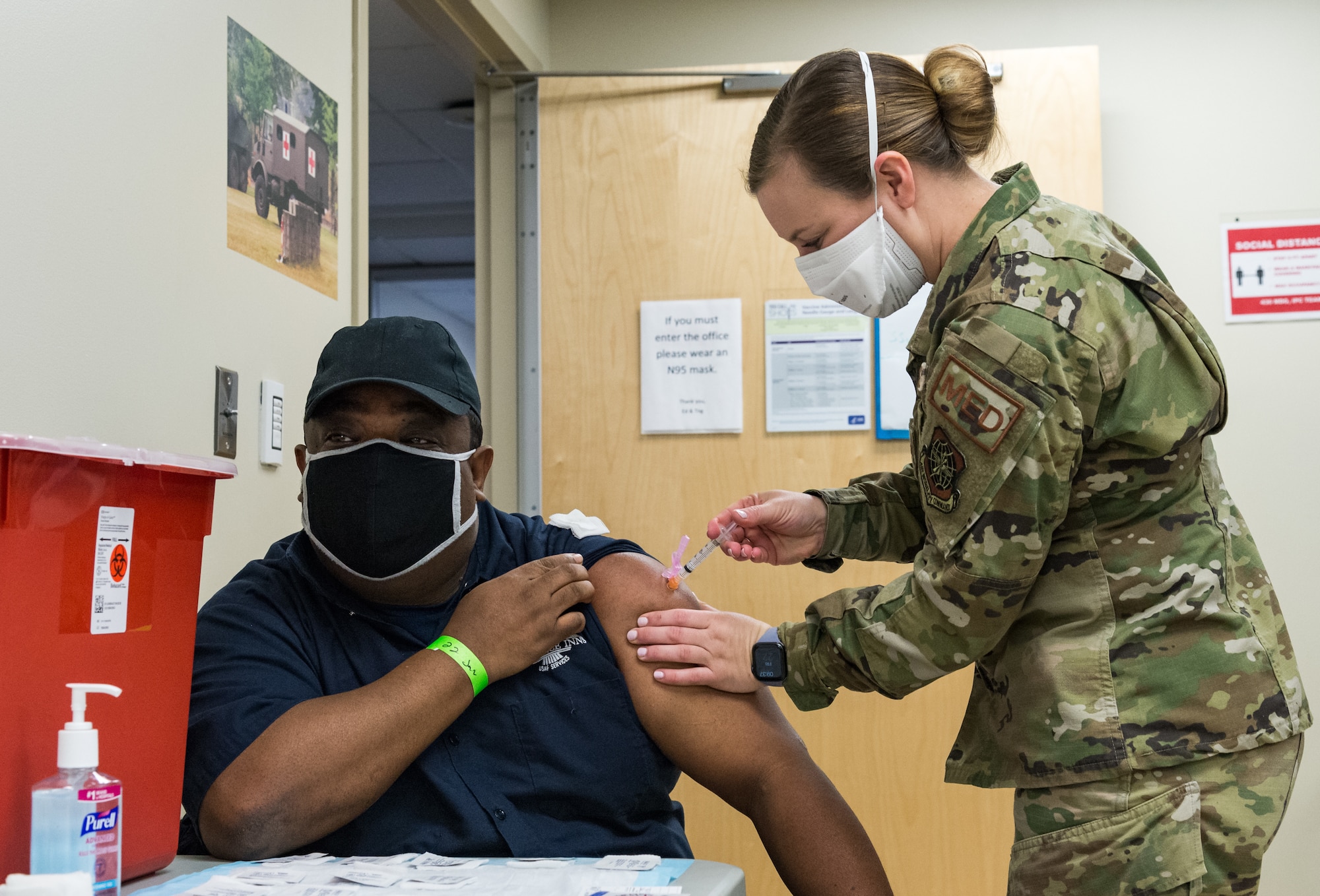 Henry Daniel, 436th Force Support Squadron material handler, is administered the COVID-19 vaccine by Staff Sgt. Kelsey Loeser, 436th Medical Group unit training manager, Jan. 22, 2021, at Dover Air Force Base, Delaware. Daniel was among the first Team Dover front-line workers who voluntarily received the vaccine in accordance with Department of Defense guidance. The vaccine was granted emergency use authorization by the U.S. Food and Drug Administration for use in prevention of COVID-19. (U.S. Air Force photo by Roland Balik)