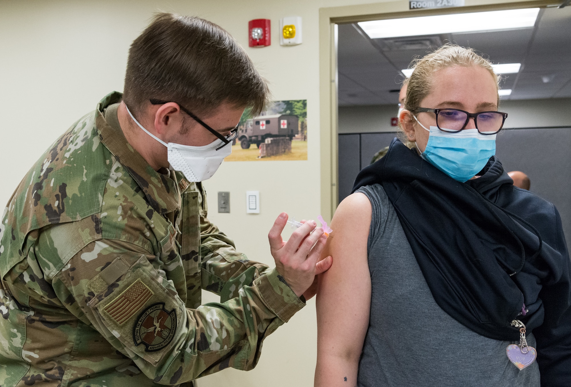 Sarah Carter, Defense Commissary Agency worker, receives the COVID-19 vaccine administered by Staff Sgt. Logan Hallman, 436th Healthcare Operations Squadron education and training noncommissioned officer in charge, Jan. 22, 2021, at Dover Air Force Base, Delaware. Carter was among the first Team Dover front-line workers who voluntarily received the vaccine in accordance with Department of Defense guidance. The vaccine was granted emergency use authorization by the U.S. Food and Drug Administration for use in prevention of COVID-19. (U.S. Air Force photo by Roland Balik)