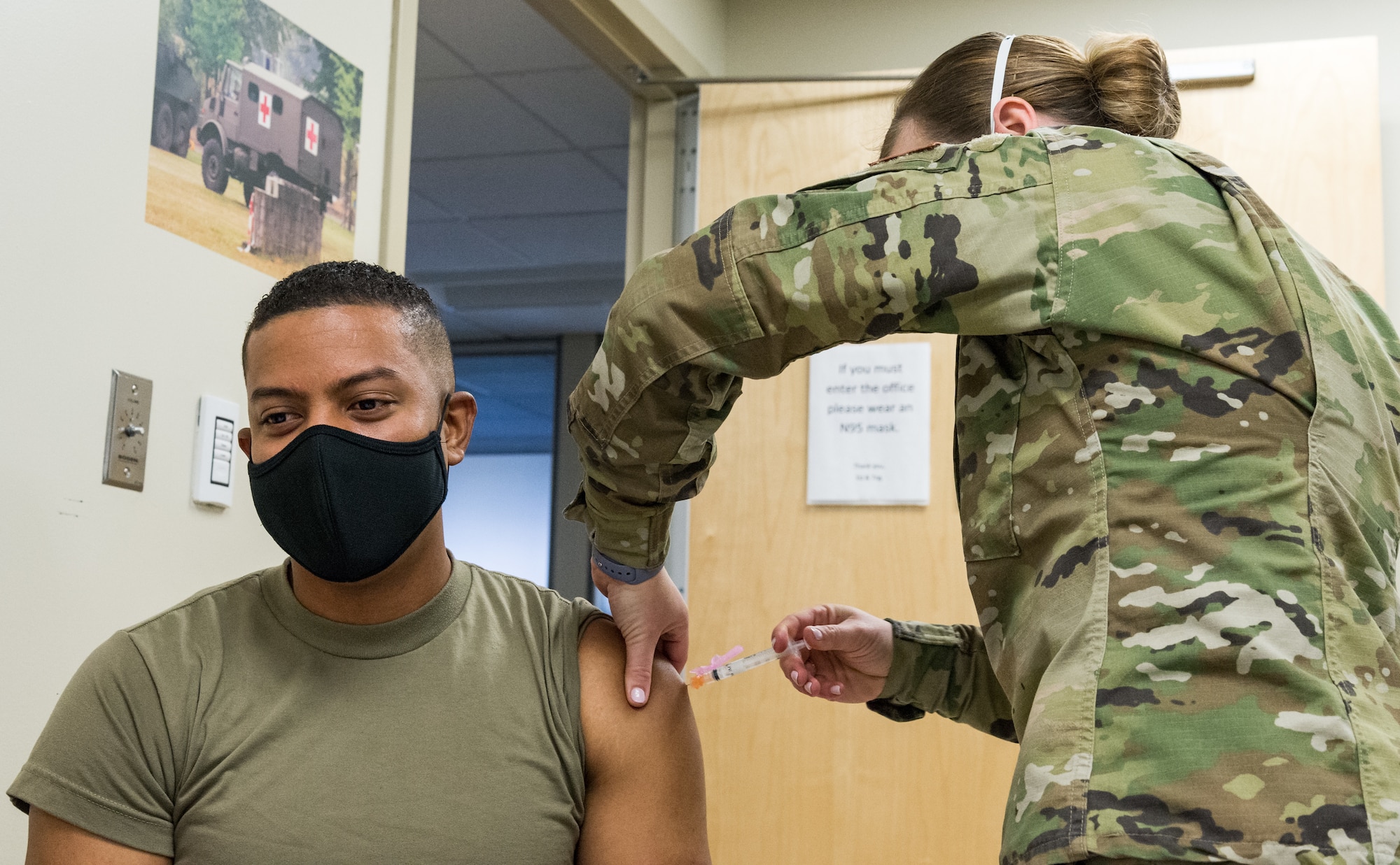 Master Sgt. Andrew Burgos, 436th Operational Medical Readiness Squadron mental health flight chief, receives the COVID-19 vaccine administered by Staff Sgt. Kelsey Loeser, 436th Medical Group unit training manager, Jan. 22, 2021, at Dover Air Force Base, Delaware. Burgos was among the first Team Dover front-line workers who voluntarily received the vaccine in accordance with Department of Defense guidance. The vaccine was granted emergency use authorization by the U.S. Food and Drug Administration for use in prevention of COVID-19. (U.S. Air Force photo by Roland Balik)