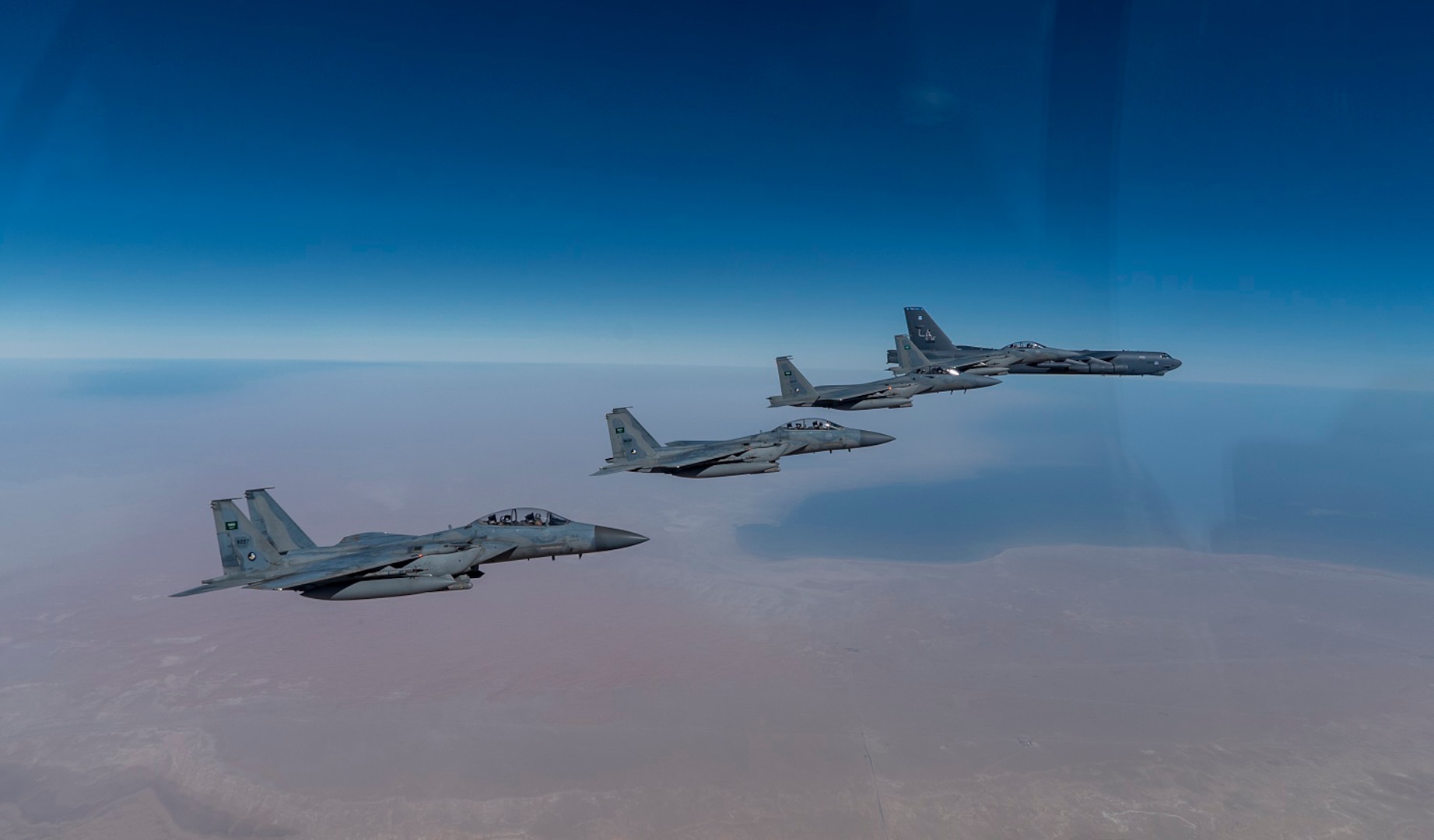 A U.S. Air Force B-52 Stratofortress  from the 2nd Bomb Wing, Barksdale Air Force Base, LA, flew with Royal Saudi Arabian Air Force F-15SAs during a bomber task force mission over the U.S. Central Command area of responsibility, Jan. 27, 2021. The bomber deployment underscores the U.S. Military's commitment to regional security and demonstrates a unique ability to rapidly deploy on short notice. The B-52 is a long-range, heavy bomber that is capable of flying at high subsonic speeds of altitudes of up to 50,000 feet and provides the United States with a global strike capability. (U.S. Air Force photo by Senior Airman Roslyn Ward)