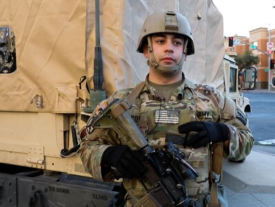 U.S. Army Cpl. David Campbell, an infantryman with the California National Guard's Headquarters and Headquarters Company, 1st Battalion, 184th Infantry Regiment, provided aid at the scene of a car accident while guarding the Robert T. Matsui United States Courthouse in Sacramento, California., Jan. 19, 2021. Campbell received recognition and a division coin from U.S. Army Col. Robert Wooldridge, deputy commander for support , 40th Infantry Division.