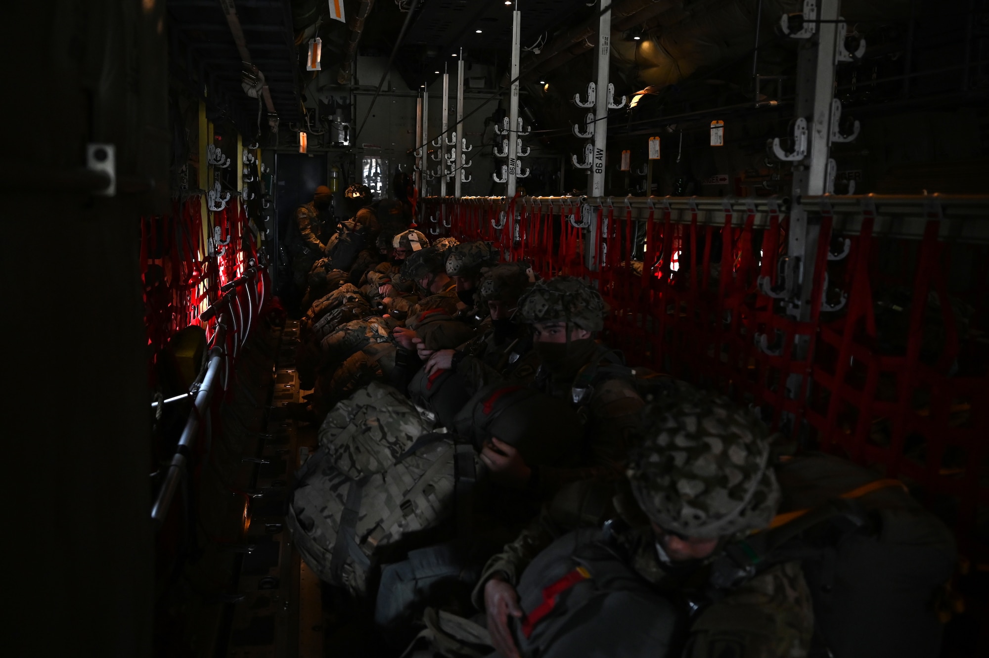U.S. Army paratroopers assigned to the 1st Squadron (Airborne), 91st Cavalry Regiment, 173rd Airborne Brigade, assigned to Grafenwoehr Training Area, Germany, sit in a U.S. Air Force C-130J Super Hercules aircraft prior to a military static line jump.