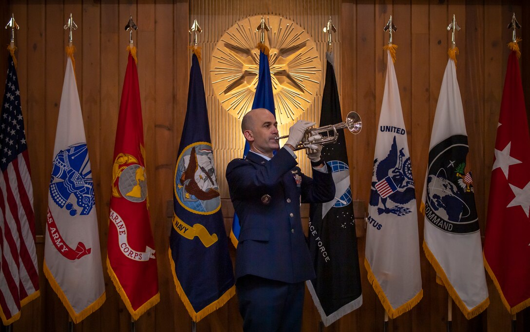 U.S. Air Force Lt. Col. Kevin Amsden, executive officer to the United States Space Command commander, performs taps during the Gold Star flag dedication ceremony Jan. 25, 2021, at the Peterson-Schriever Garrison Chapel. Taps, a bugle call, is typically played during flag ceremonies and funerals for military service members to pay tribute to their service.