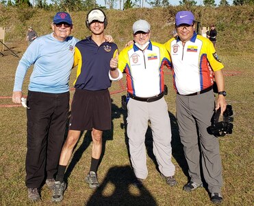 The United States Practical Shooting Association attracts shooters from other countries. Lt. Col. Koh poses with the Ecuador Team at the Florida Sectional Championship.