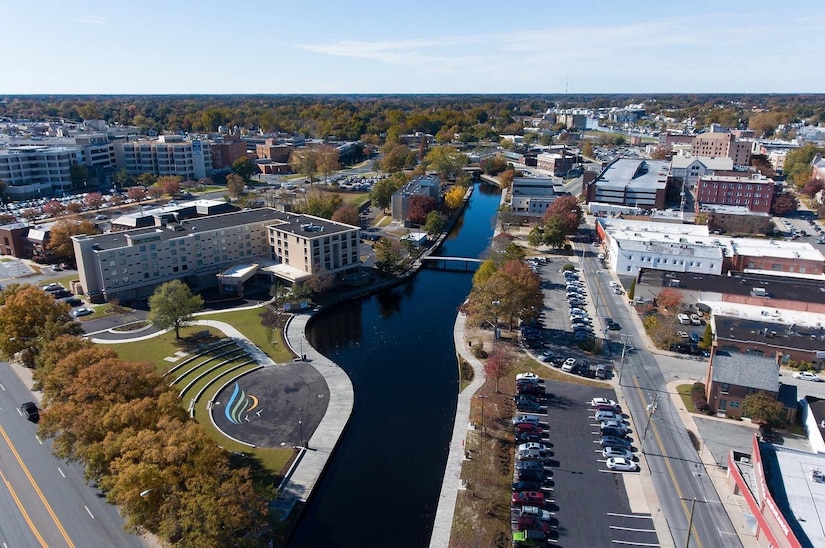 An aerial view of a river that runs through a downtown area.