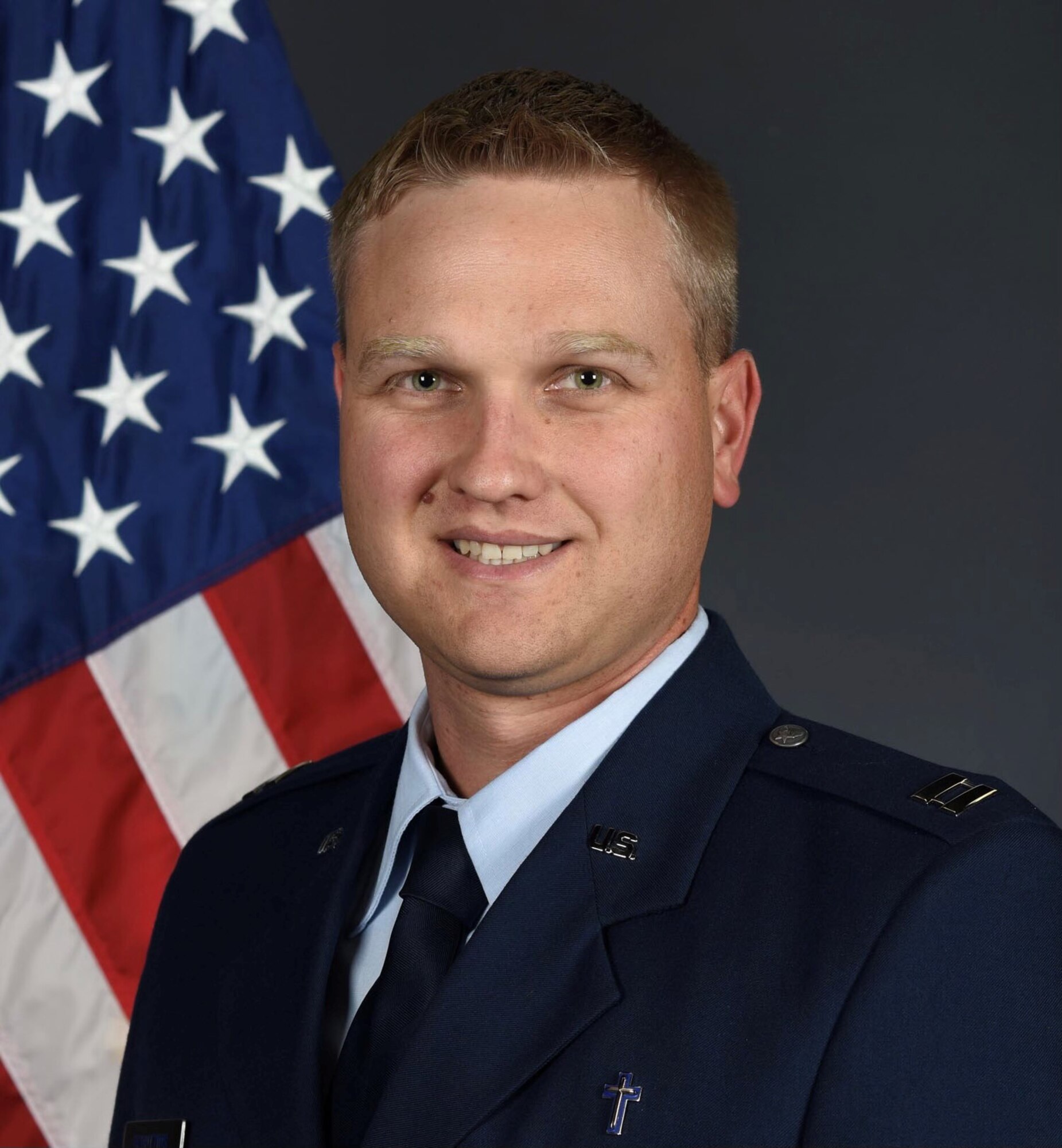 Chaplain Brett Barner poses with a C-130.