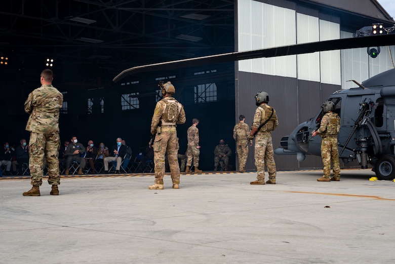 A photo of community members applauding an aircraft unveiling
