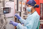 Photo of an U.S. Air Force nurse preparing medical equipment for incoming patients within the emergency department of Del Sol Medical Center, El Paso, Texas.