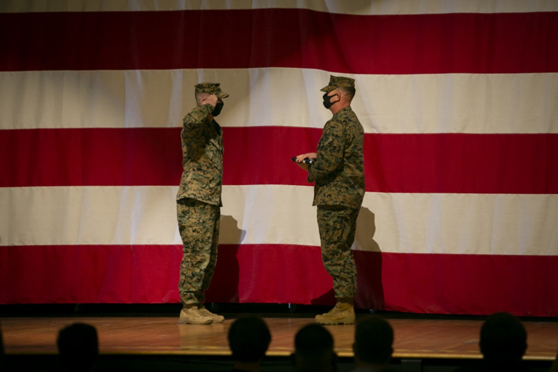U.S. Marine Corps Sgt. Maj. John K. Lewis, the prior sergeant major of Headquarters and Headquarters Squadron, Marine Corps Air Station Miramar, salutes the national colors during the Old Glory presentation after his retirement ceremony on MCAS Miramar, California, Dec. 3, 2020. Lewis served twenty-four years of honorable and faithful service in the Marine Corps. (U.S. Marine Corps photos by Lance Cpl. Krysten Houk)