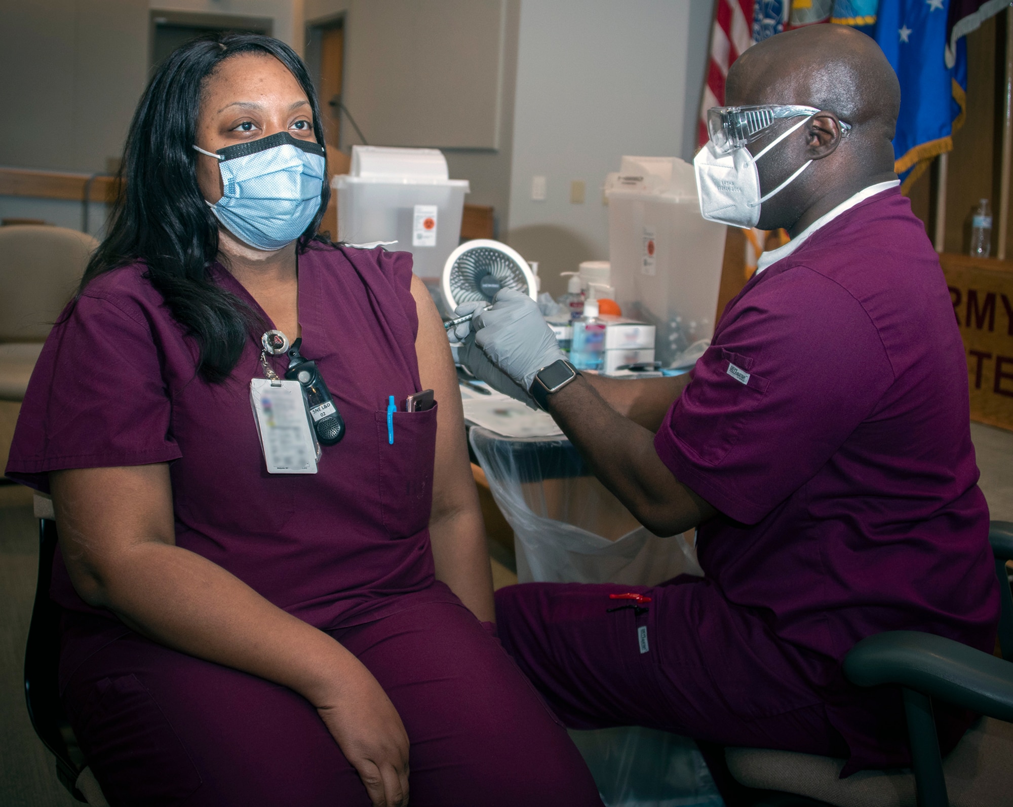 Carlton Chase, licensed vocational nurse, administers the COVID-19 vaccine to Christy Jackson, OB-GYN midwife, at Brooke Army Medical Center, Joint Base San Antonio-Fort Sam Houston Jan. 26.
