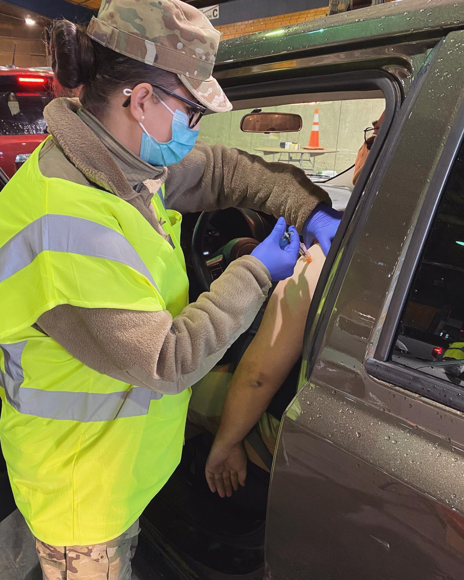 Oregon Air National Guard Tech. Sgt. Meghan Olson, 173rd Fighter Wing, administers a COVID-19 vaccine at a drive-thru vaccination clinic in Medford, Oregon, Jan. 22, 2021. Twelve Airmen from Kingsley Field are on state active duty as part of Task Force Guardian supporting COVID-19 vaccine clinics in Southern Oregon.