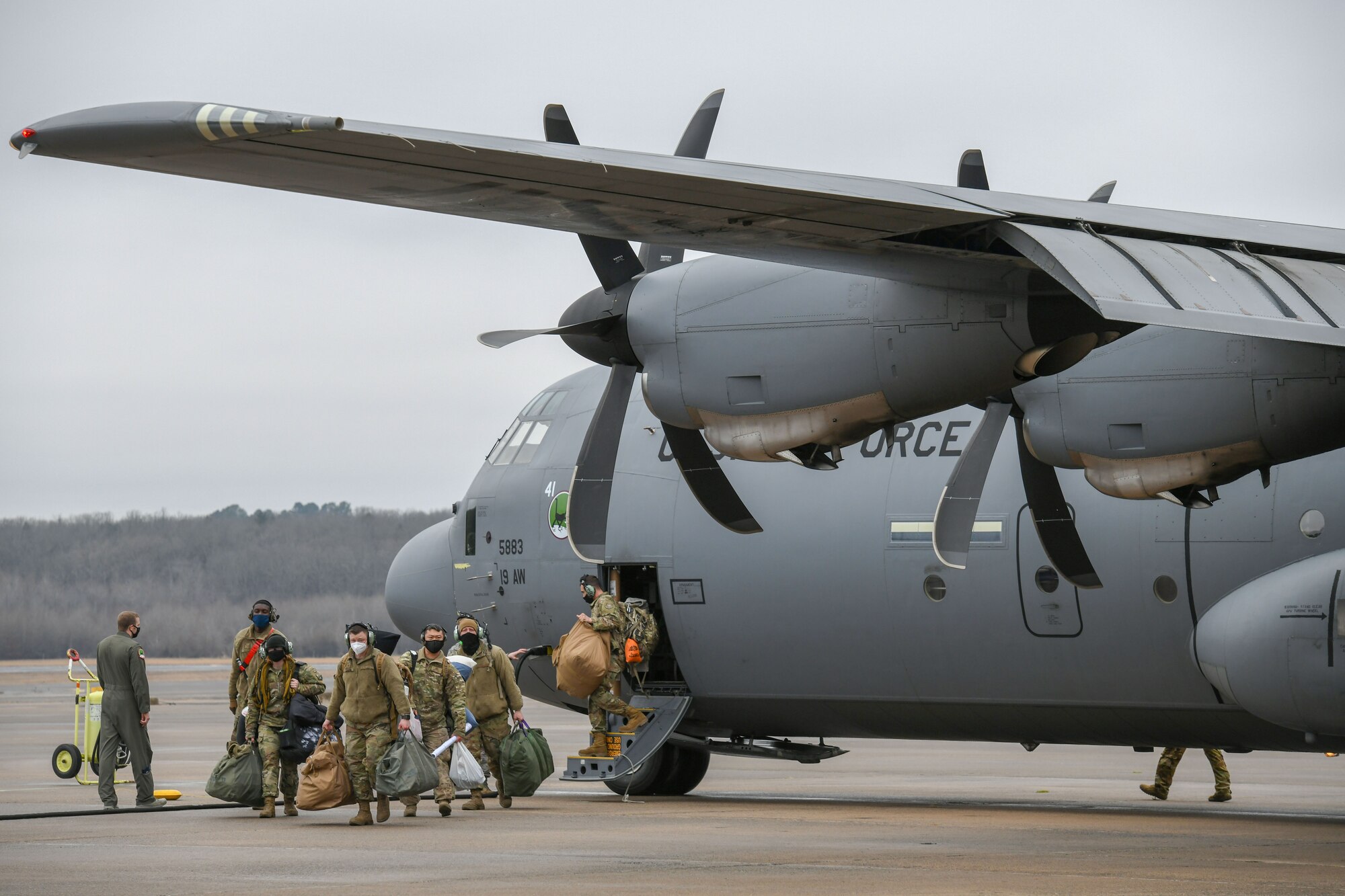 A group of people depart an aircraft