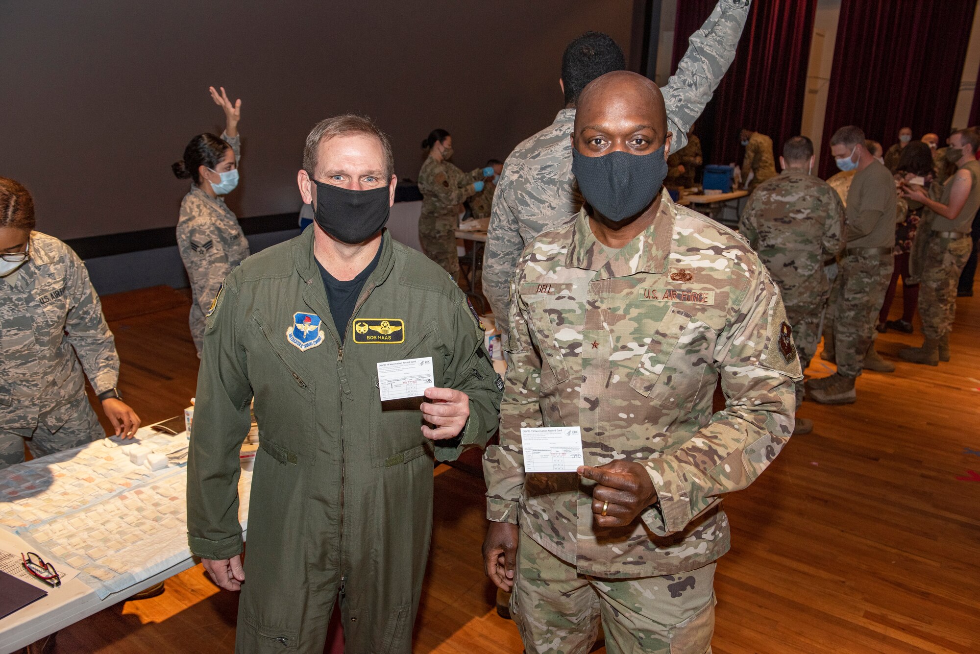 Brig. Gen. Kenyon Bell, right, installation and 82nd Training Wing commander, and Col. Robert Haas, 80th Flying Training Wing commander, show their COVID-19 vaccine shot record