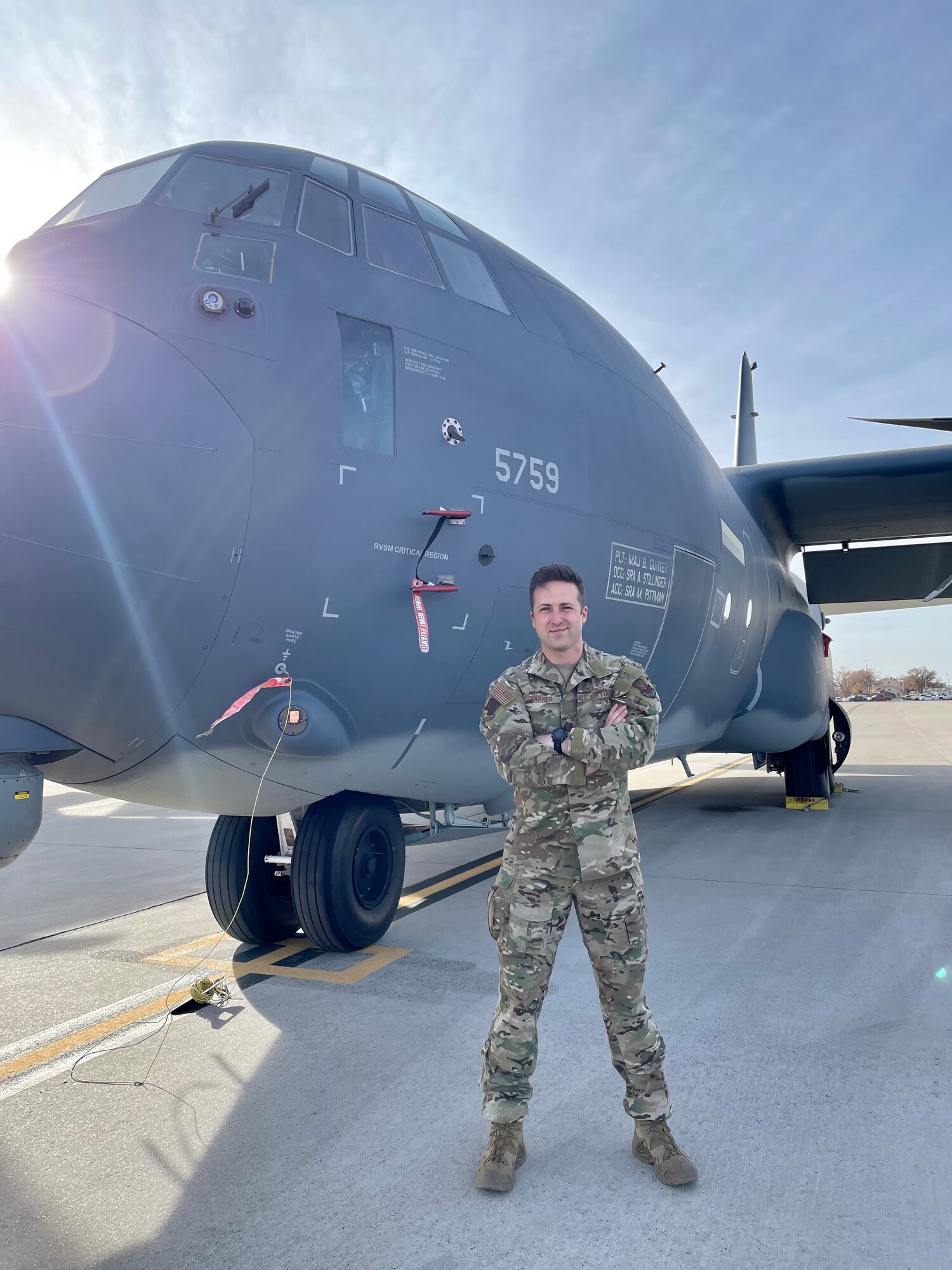 Chaplain Brett Barner poses with a C-130.