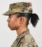 A female Soldier poses for an example photo with medium-length hair secured into a ponytail to support an upcoming change to Army grooming and appearance standards. Medium-length ponytails are only authorized for wear on the back of the scalp and cannot exceed the head's width or interfere with a Soldier's headgear.
