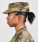 A female Soldier poses for an example photo with medium-length hair secured into a ponytail to support an upcoming change to Army grooming and appearance standards. Medium-length ponytails are only authorized for wear on the back of the scalp and cannot exceed the head's width or interfere with a Soldier's headgear.