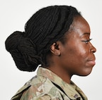 A female Soldier poses for an example photo wearing "locs" and multiple hairstyles to illustrate an upcoming change to Army grooming and appearance standards. Soldiers will be authorized to wear multiple hairstyles if they can maintain a neat and professional appearance, and if the hairstyle doesn't impede the use of headgear or other equipment.