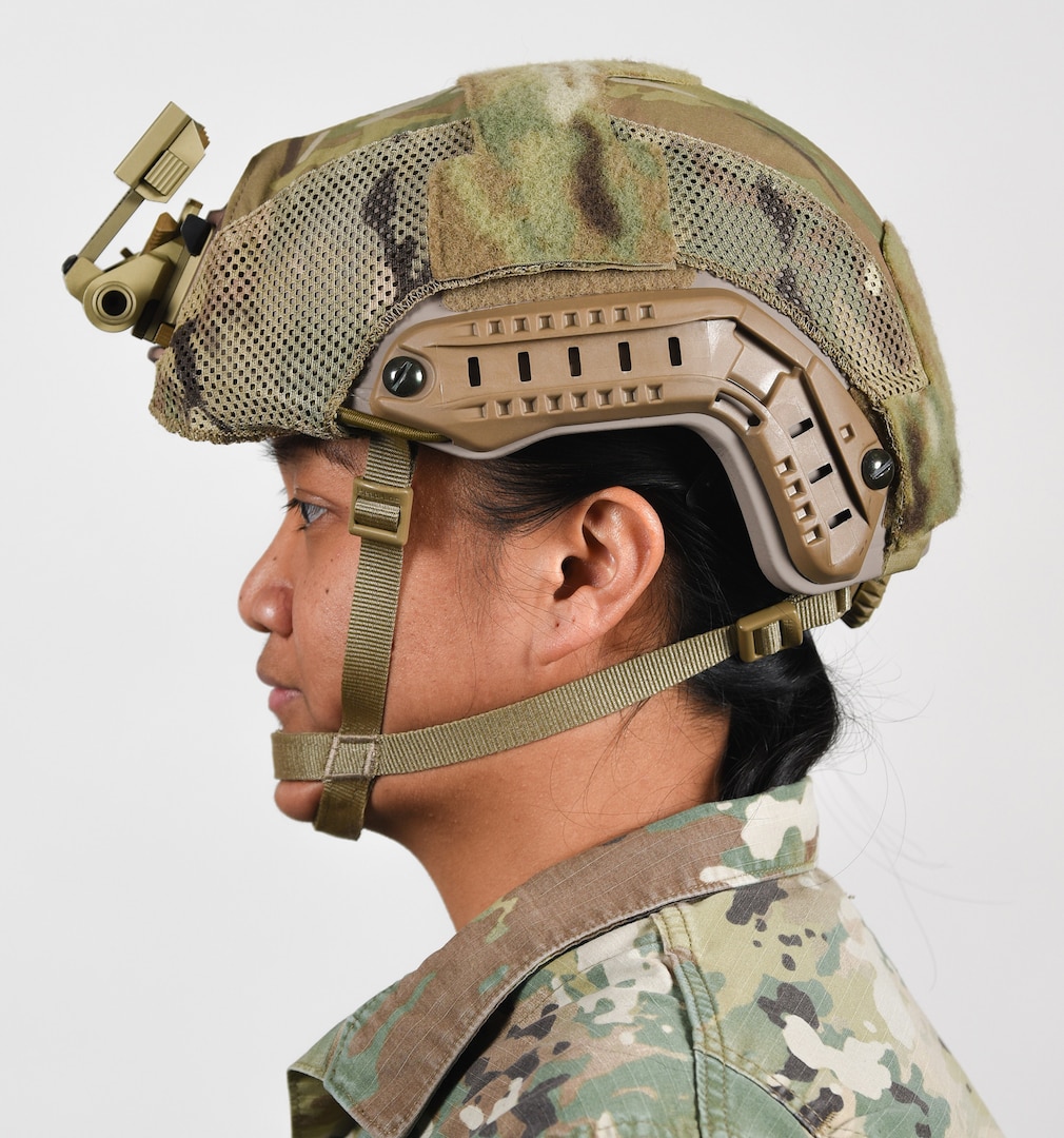 A female Soldier poses for an example photo with long hair while wearing tactical headgear to illustrate an upcoming change in Army grooming and appearance standards. The Soldier's hair is secured into a long ponytail and tucked underneath her Army Combat Uniform collar. Females with long hair will now have the option to wear a ponytail while wearing an Army Physical Fitness Uniform, conducting physical training in a utility uniform, or while wearing tactical headgear or other equipment.