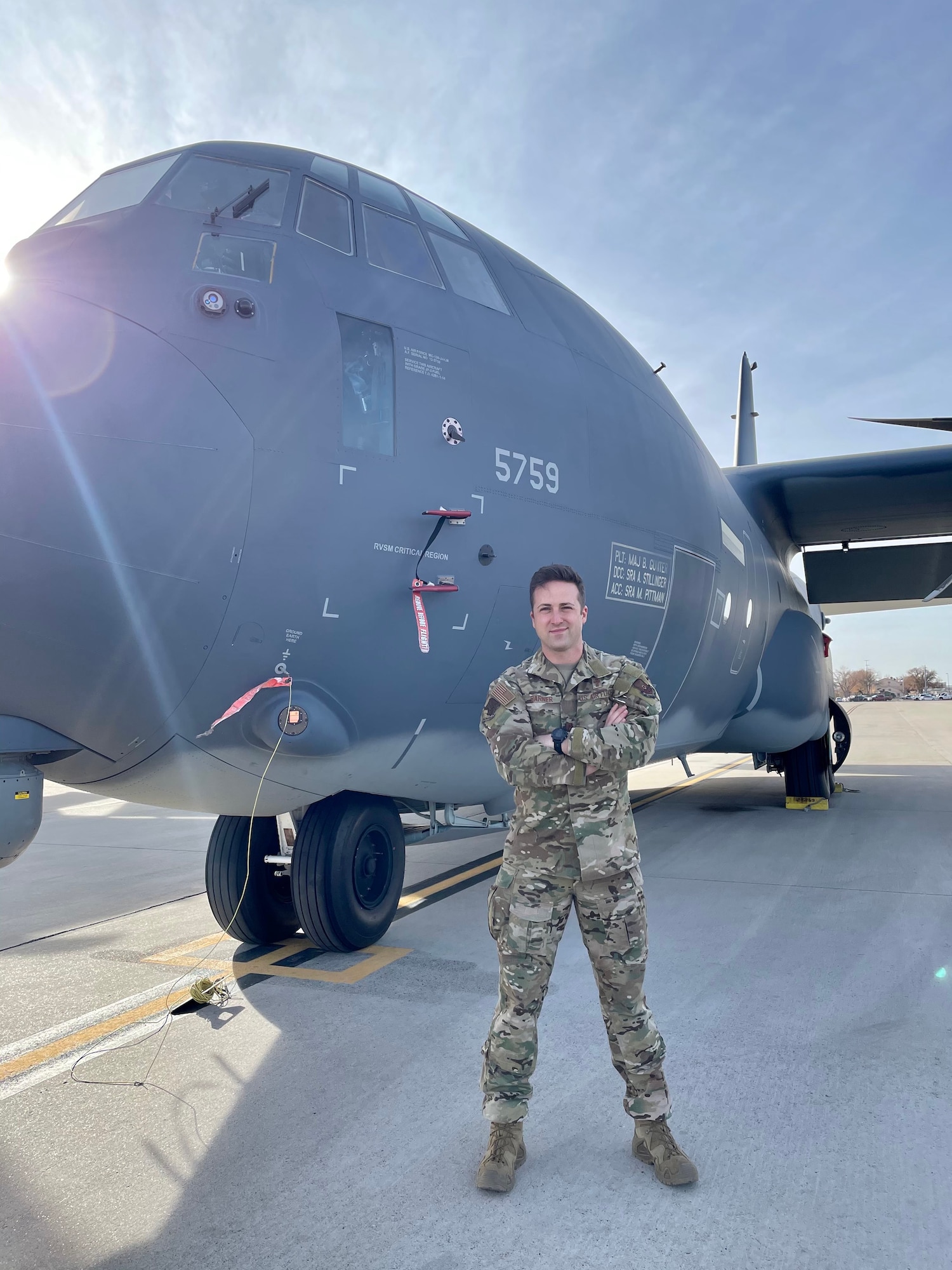 Chaplain Brett Barner poses with a C-130.
