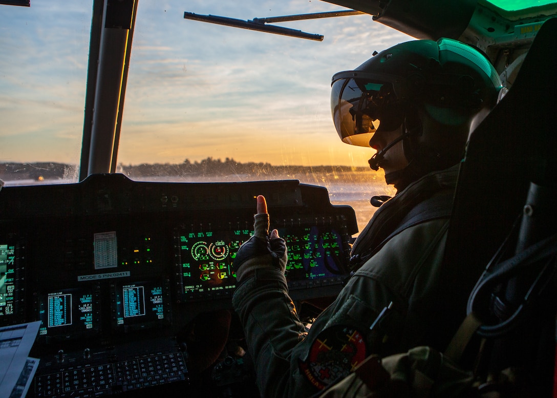 A UH-1Y Huey pilot communicates with his flight crew at Alpena Combat Readiness Training Center, Mich., Jan. 25.
