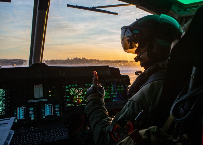 A UH-1Y Huey pilot communicates with his flight crew at Alpena Combat Readiness Training Center, Mich., Jan. 25.