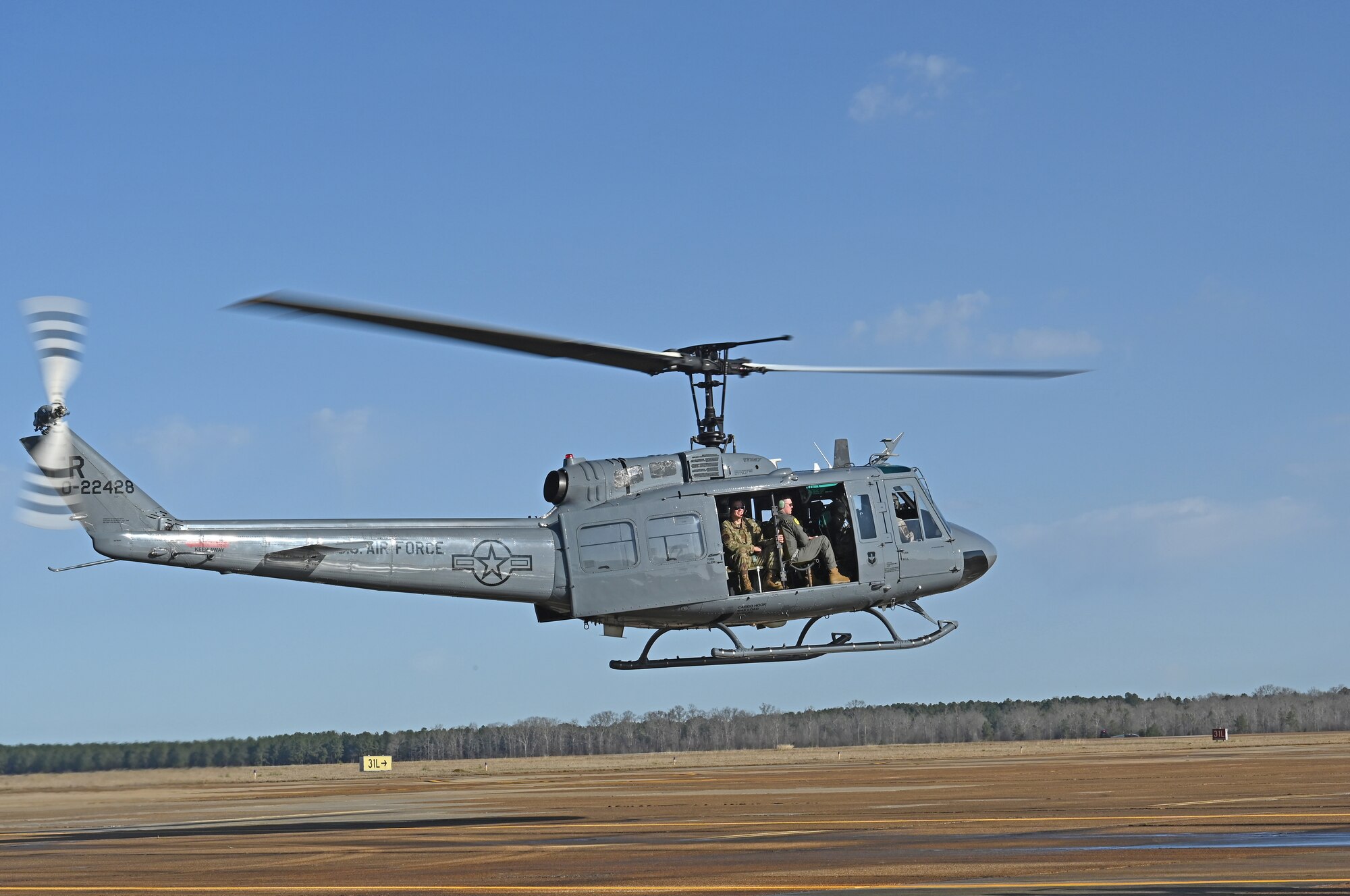 A U.S. Air Force TH-1H piloted by 1st Lt. Austin Kong, 23rd Flying Training Squadron instructor pilot, hovers above the flight line in preparation for take-off on Columbus Air Force Base, Miss., Jan. 26, 2021. The 23rd Flying Training Squadron was at Columbus AFB to receive physiological and attitude chamber training provided by the 14th Operations Support Squadron. (U.S. Air Force photo by Airman 1st Class Jessica Haynie)