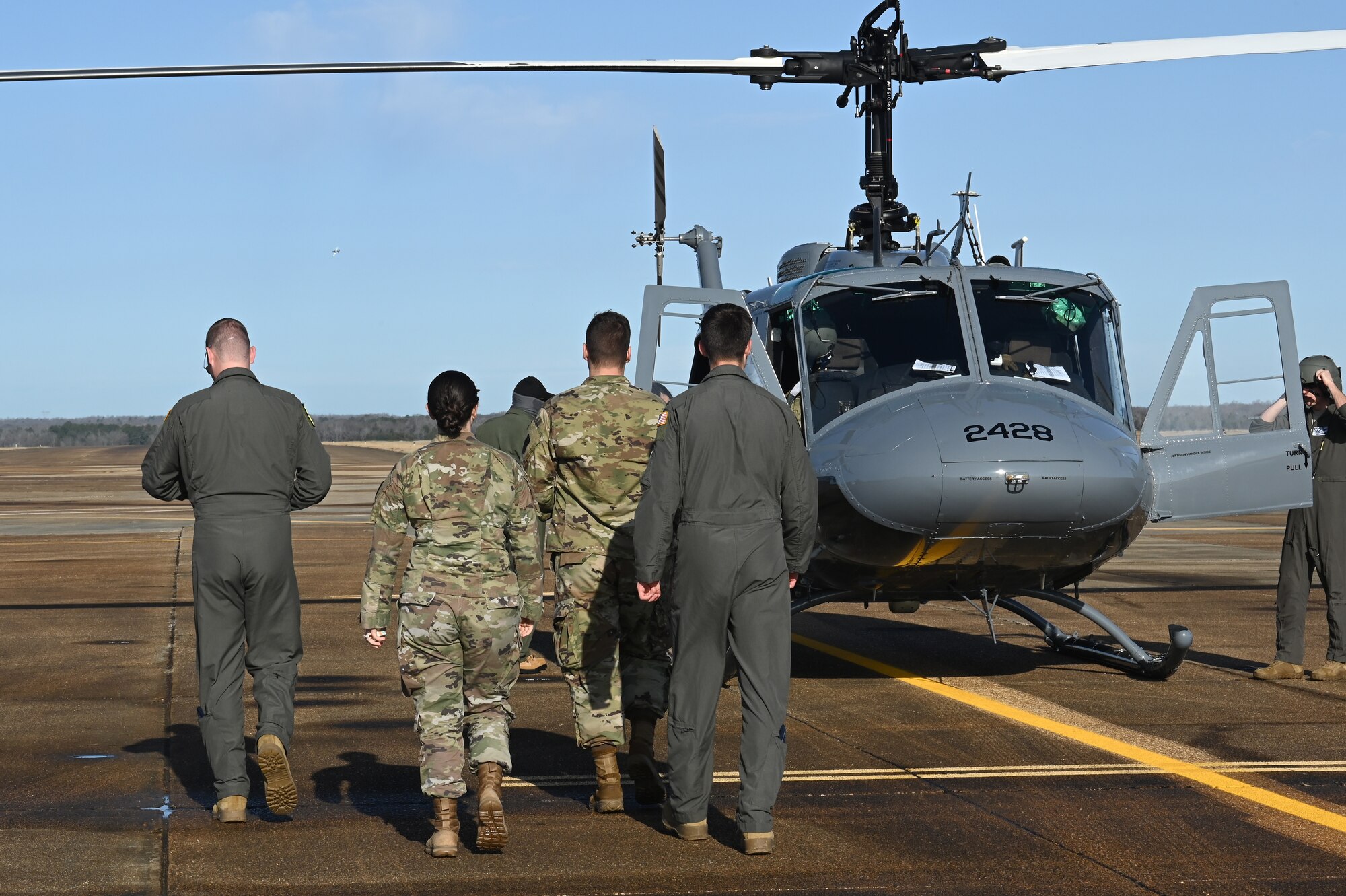 U.S. Air Force student pilots assigned to the 14th Flying Training Wing on prepare for an aircraft familiarization flight on the TH-1H provided by the 23rd Flying Training Squadron at Fort Rucker Ala., Jan. 26, 2021, on Columbus Air Force Base, Miss. The flight was an educational experience for Columbus AFB instructor and student pilots to learn about the TH-1H and its capabilities. (U.S. Air Force photo by Airman 1st Class Jessica Haynie)