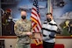 A U.S. Army commander and a safety officer hold and display an award.